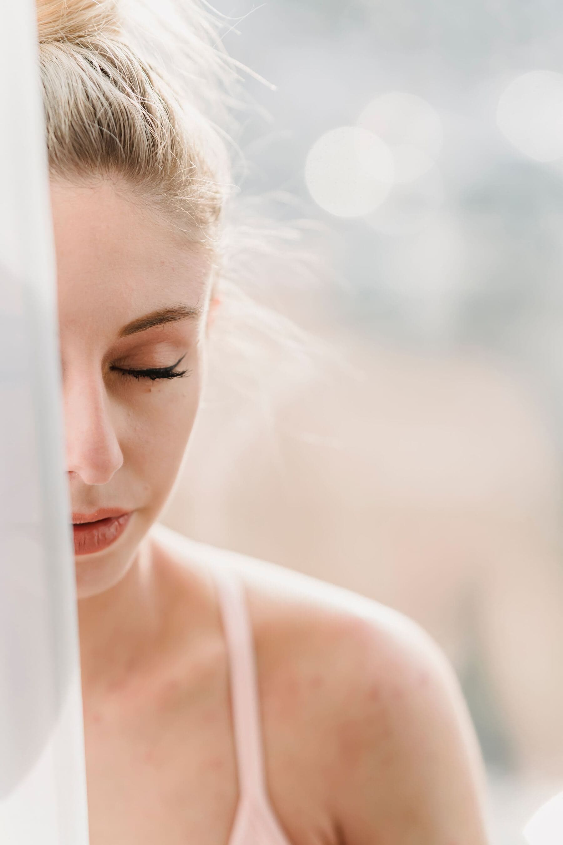 A person sitting calmly with eyes closed in morning light